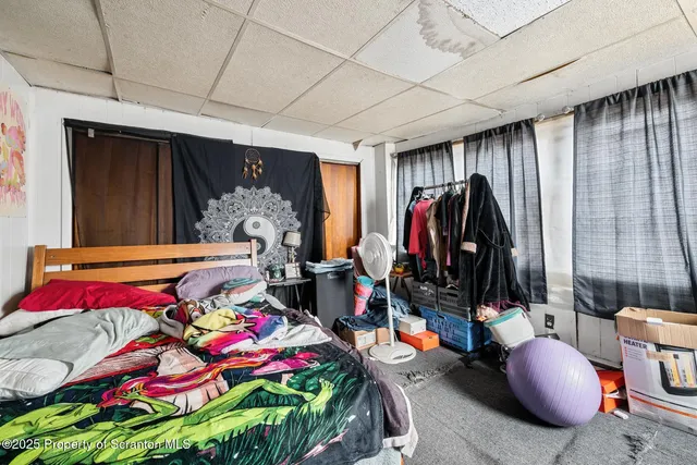 a bedroom with bed and a window