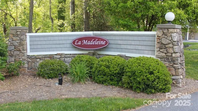 a view of a sign under a tree