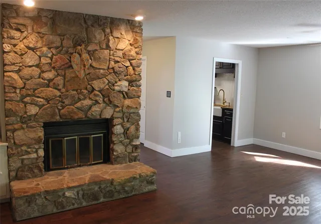 a living room with a fireplace and a walk in closet