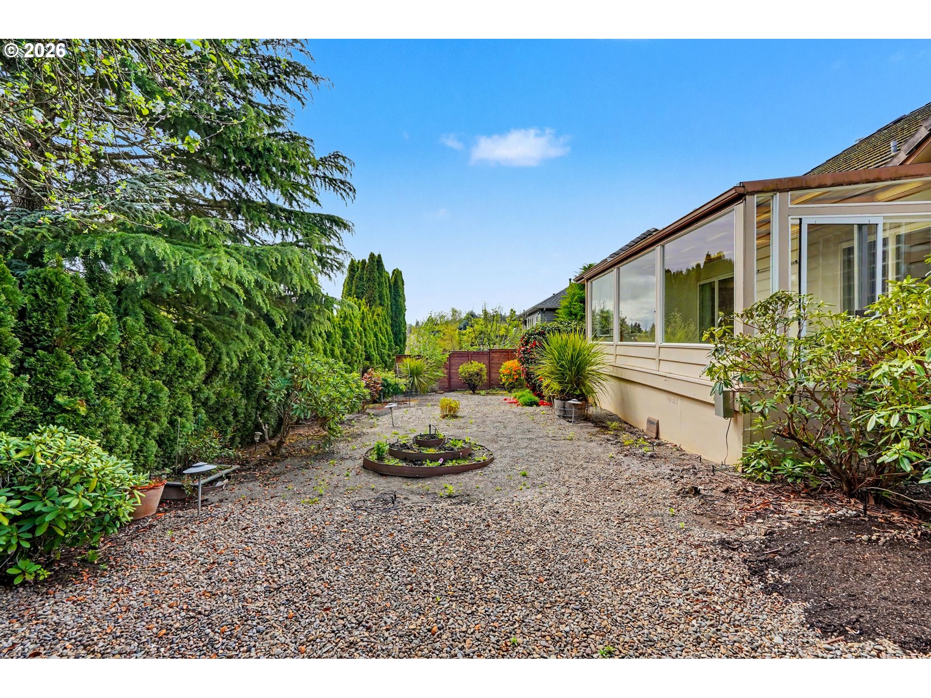 1470 Ranier Loop Northwest Salem, OR 97304 - Photo 46 of 48 a view of a backyard with plants and a tree