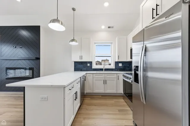 a kitchen with a sink stainless steel appliances and cabinets