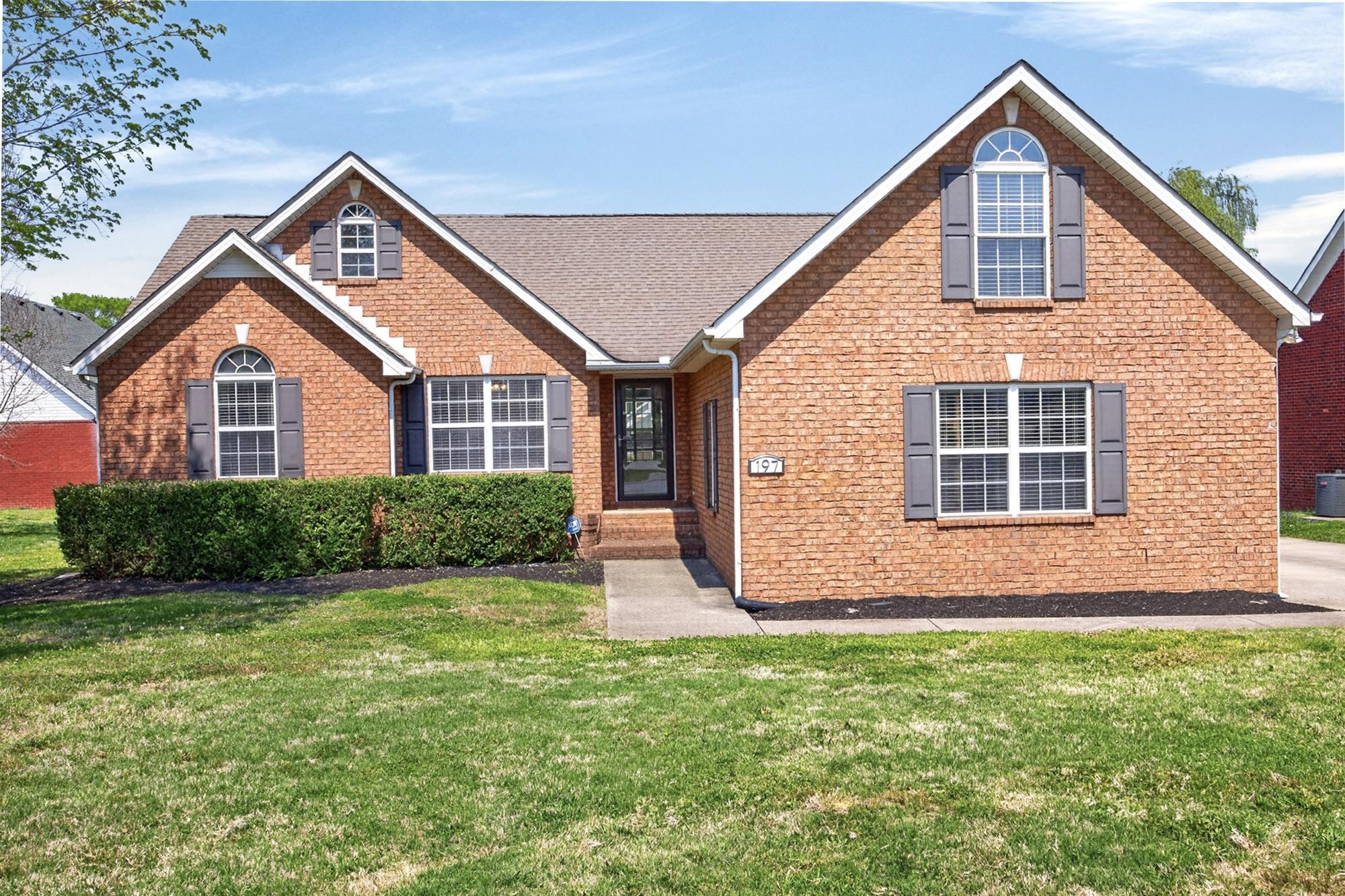 a front view of a house with a yard