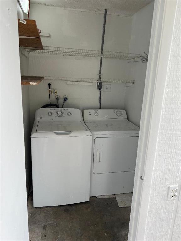 9920 Northwest 68th Place, Unit 210 Tamarac, FL 33321 - Photo 17 of 26 a utility room with dryer and washer