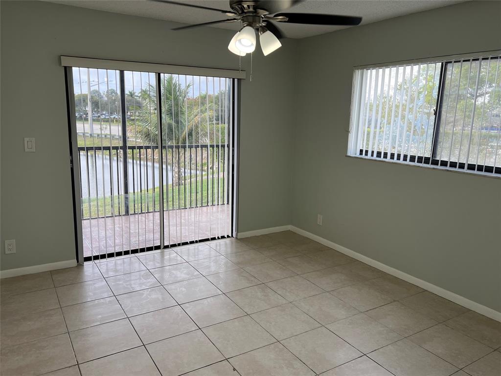 9920 Northwest 68th Place, Unit 210 Tamarac, FL 33321 - Photo 22 of 26 a view of a livingroom with a large window