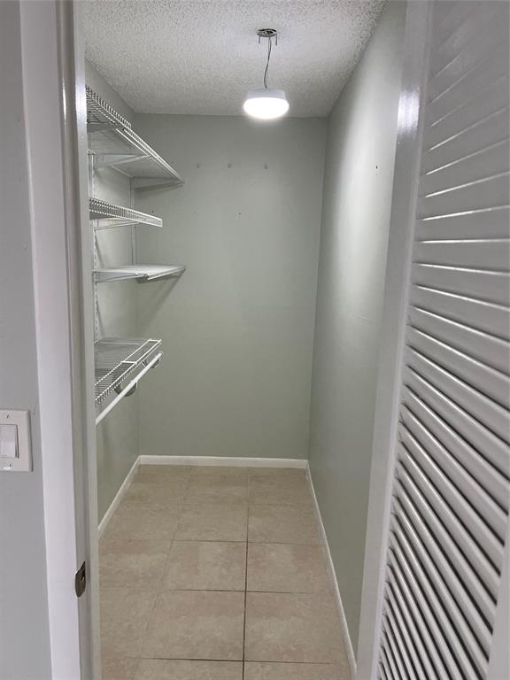 9920 Northwest 68th Place, Unit 210 Tamarac, FL 33321 - Photo 23 of 26 a view of a room with rack on the wall
