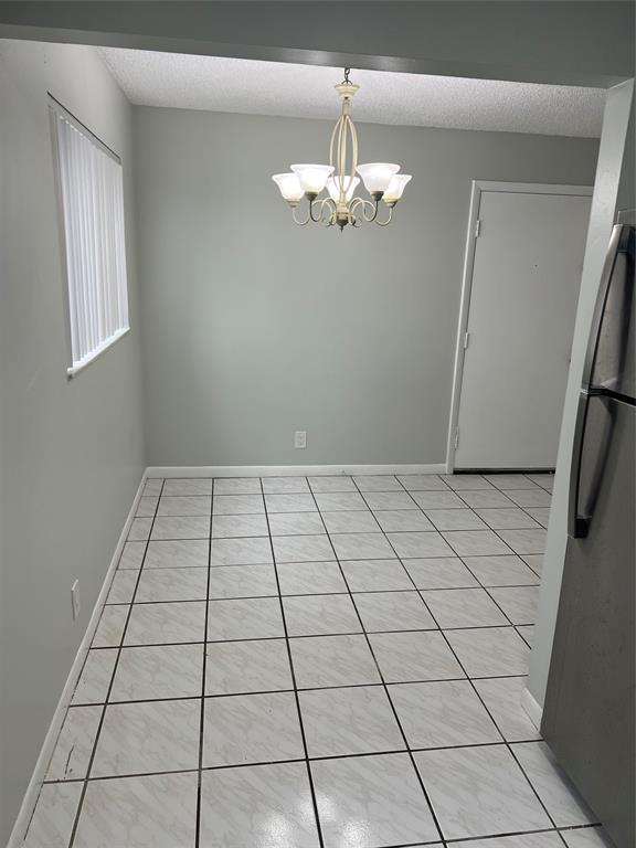 9920 Northwest 68th Place, Unit 210 Tamarac, FL 33321 - Photo 25 of 26 a view of an empty room with a window