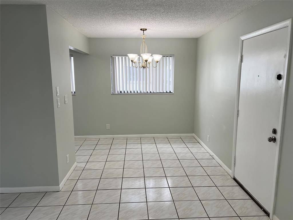 9920 Northwest 68th Place, Unit 210 Tamarac, FL 33321 - Photo 5 of 26 a view of an empty room and window