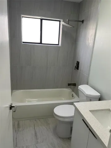 a bathroom with a toilet a sink and bathtub