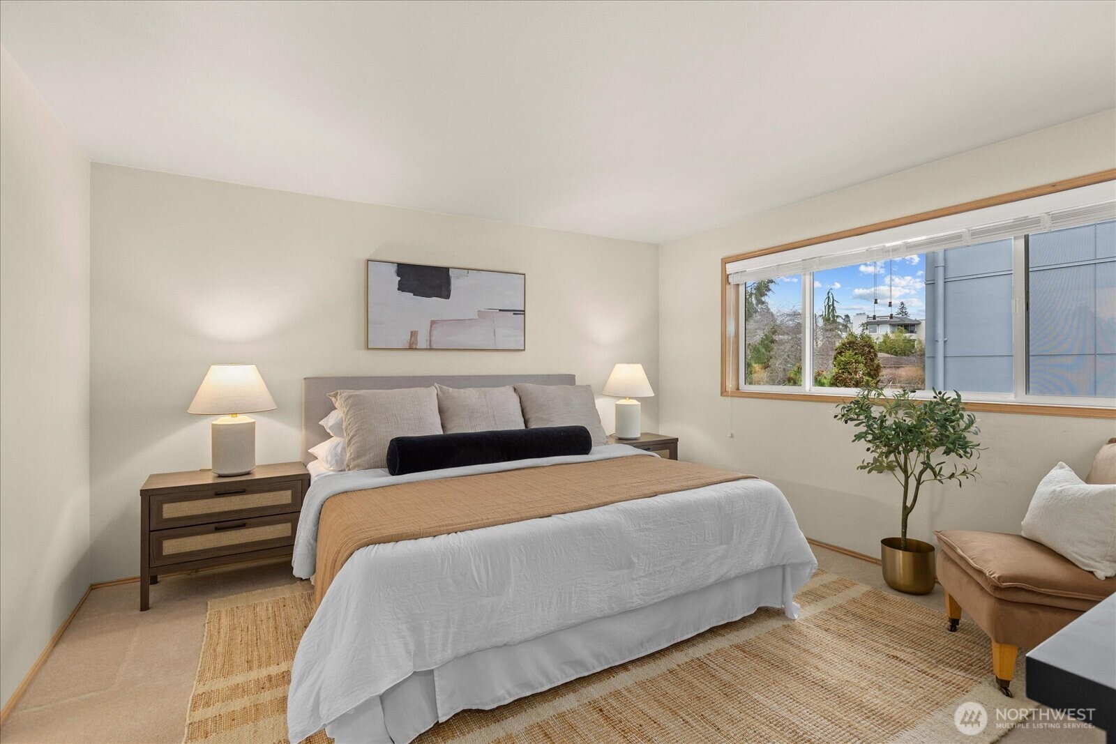 233 3rd Avenue South, Unit 305 Edmonds, WA 98020 - Photo 17 of 34 a bedroom with a bed and a potted plant