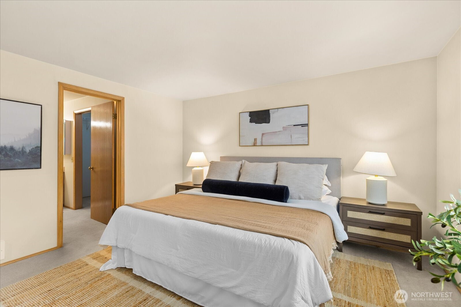 233 3rd Avenue South, Unit 305 Edmonds, WA 98020 - Photo 20 of 34 a bedroom with a bed a lamp and a potted plant