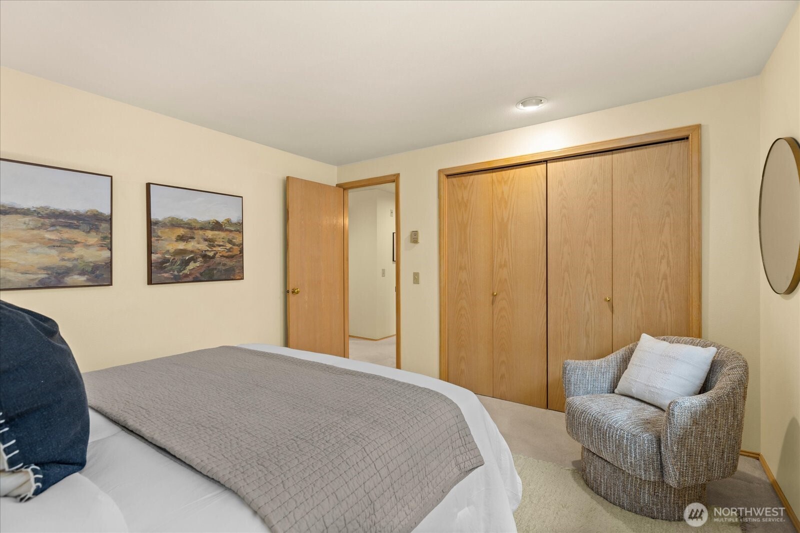 233 3rd Avenue South, Unit 305 Edmonds, WA 98020 - Photo 24 of 34 a bedroom with a large bed and a couch