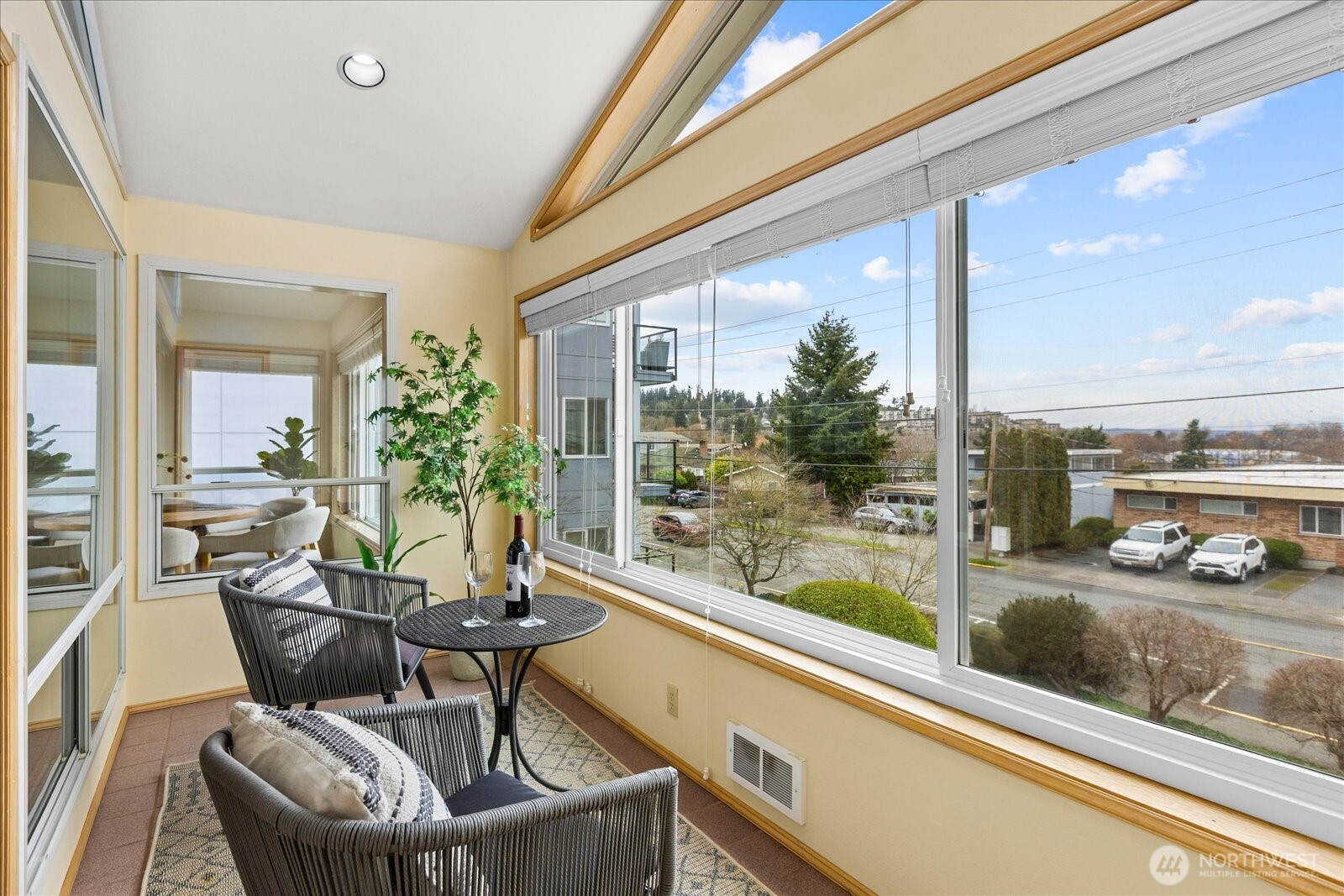 233 3rd Avenue South, Unit 305 Edmonds, WA 98020 - Photo 9 of 34 a dining room with furniture and a floor to ceiling window