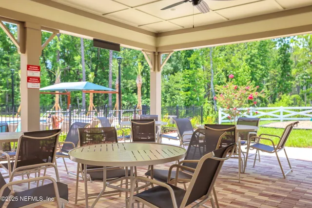 a view of chairs and table in a backyard