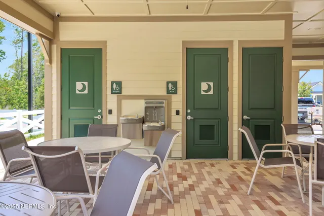 a view of a house with a yard and sitting area