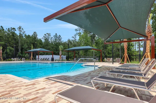a view of a patio with chairs and umbrellas on a patio