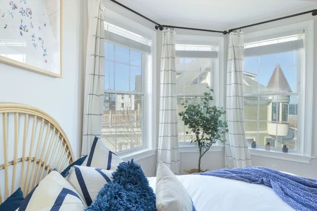 a bedroom with a bed and a window with outer view