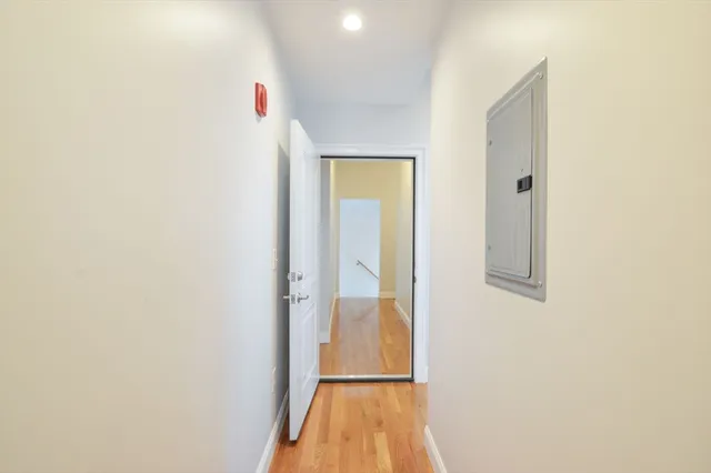 a view of a hallway with wooden floor