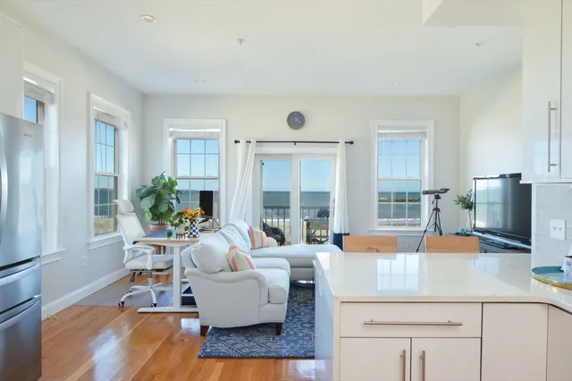 a living room with furniture and large windows