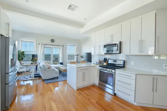 a kitchen with wooden floors and white appliances