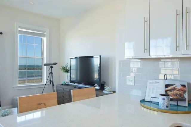 a kitchen with stainless steel appliances granite countertop a sink and a refrigerator