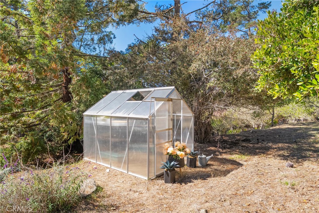 2146 Cowper Street Cambria, CA 93428 - Photo 34 of 46 Plenty of room for a garden in several areas of property, including this one with a charming little greenhouse!