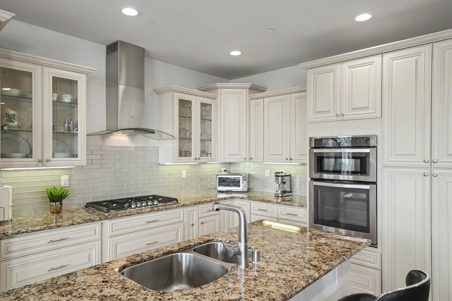 6066 Bluff View Road Copperopolis, CA 95228 - Photo 38 of 96 a kitchen with kitchen island granite countertop a sink stainless steel appliances and cabinets