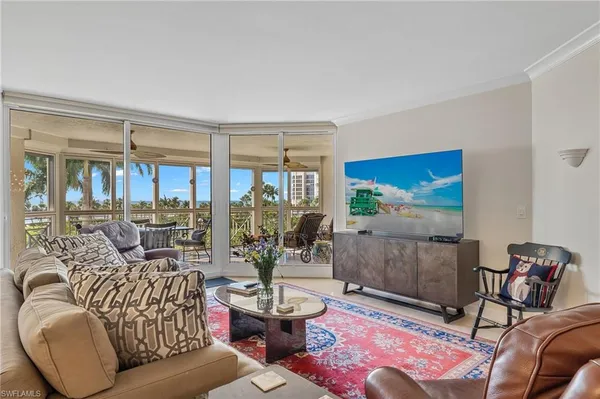 a living room with furniture and a floor to ceiling window