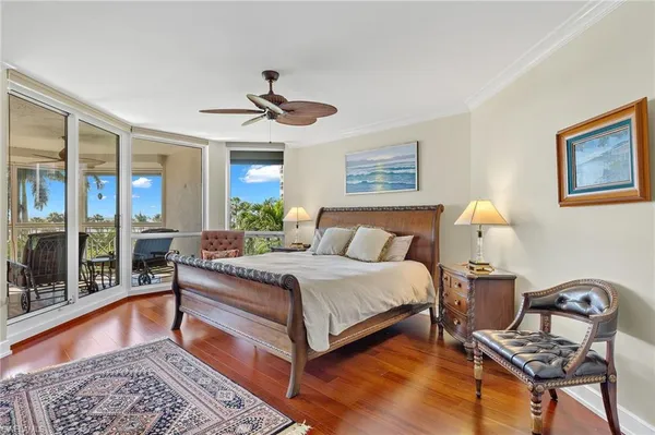 a bedroom with a bed windows and a rug