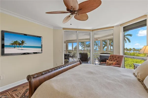 a bedroom with furniture and a large window