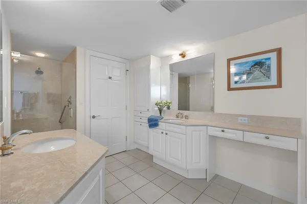 a spacious bathroom with a granite countertop sink mirror and a bathtub
