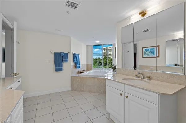 a bathroom with a sink a vanity and mirror