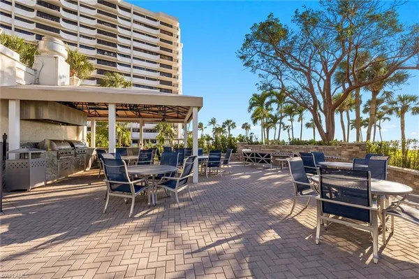 a view of a patio with dining table and chairs with wooden fence