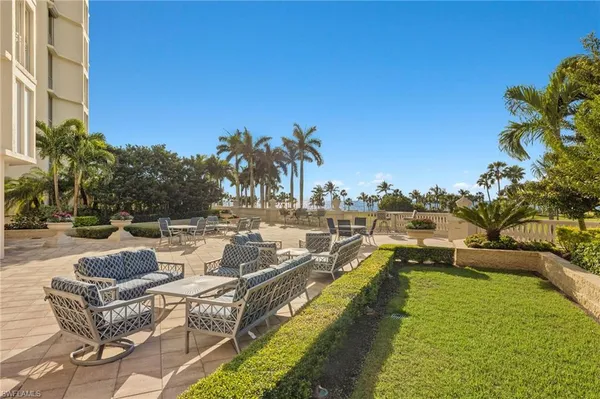 a view of swimming pool with outdoor seating and plants