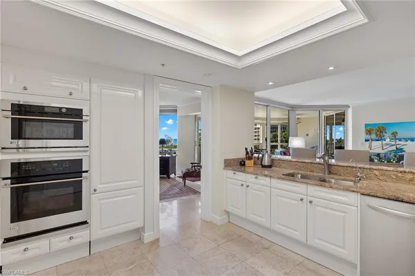 a kitchen with a sink and stainless steel appliances