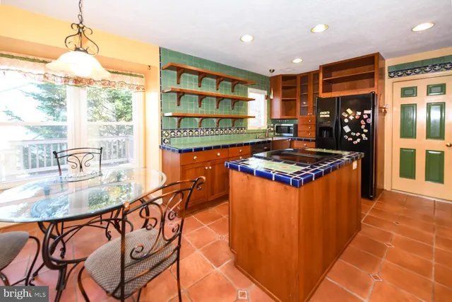 a dining room with furniture and a floor to ceiling window