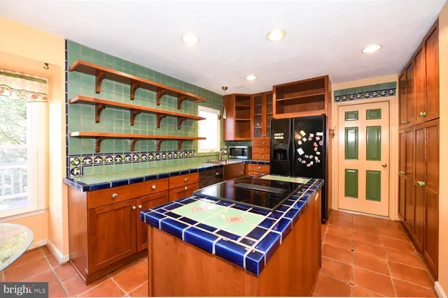 a kitchen with stainless steel appliances granite countertop a stove and a refrigerator