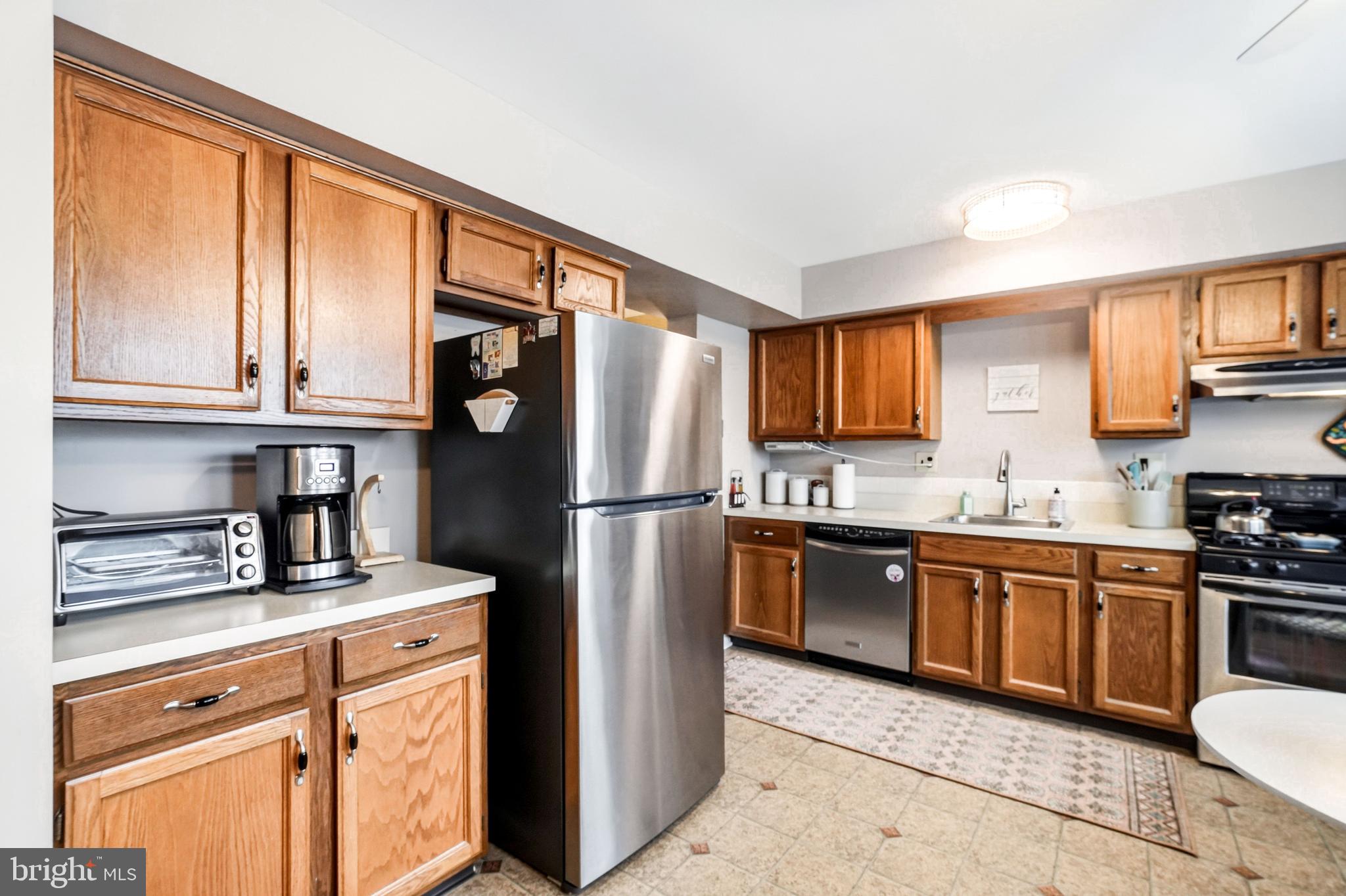 26 Blue Jay Drive Clementon, NJ 08021 - Photo 13 of 48 a kitchen with stainless steel appliances granite countertop a refrigerator stove top oven and sink