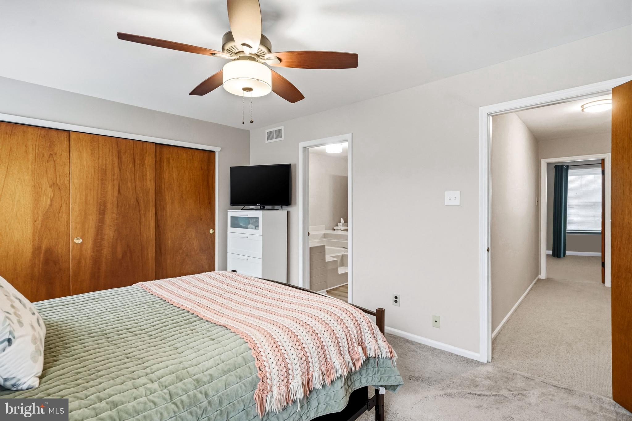 26 Blue Jay Drive Clementon, NJ 08021 - Photo 21 of 48 a bedroom with a large bed and a chandelier