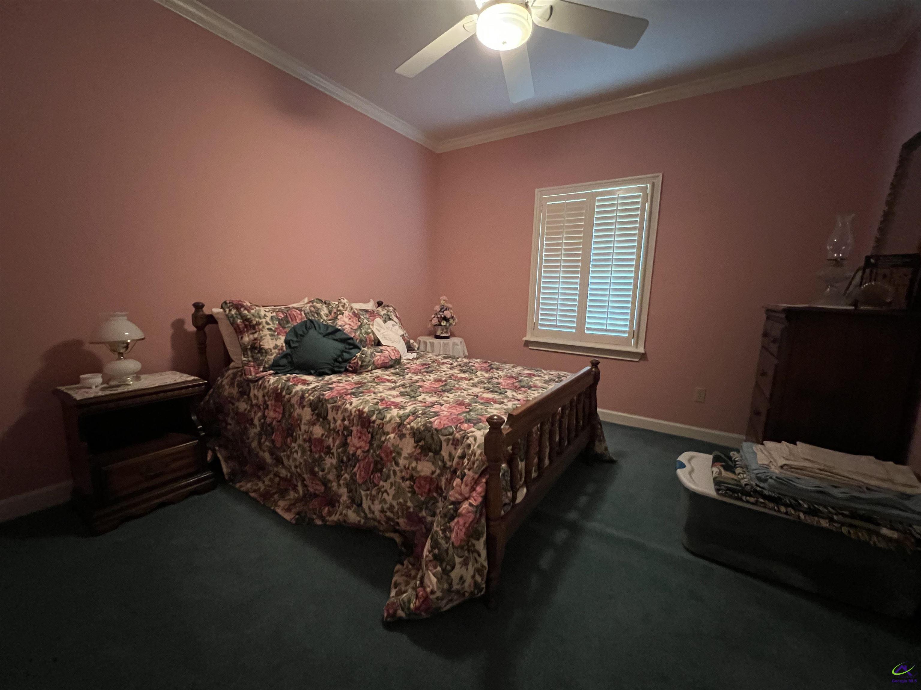 762 Nicholson-Carr Road Chester, GA 31012 - Photo 19 of 81 a bedroom with a bed and a chandelier