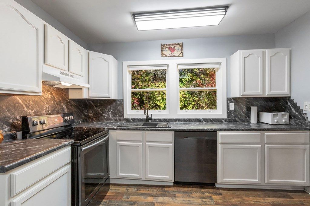 3391 Candy Mountain Road Murphy, NC 28906 - Photo 21 of 59 a kitchen with granite countertop a sink stainless steel appliances cabinets and a window