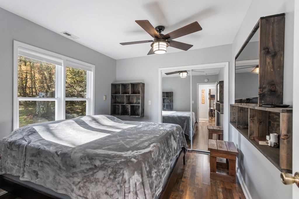 3391 Candy Mountain Road Murphy, NC 28906 - Photo 32 of 59 a bedroom with a large bed and a chandelier