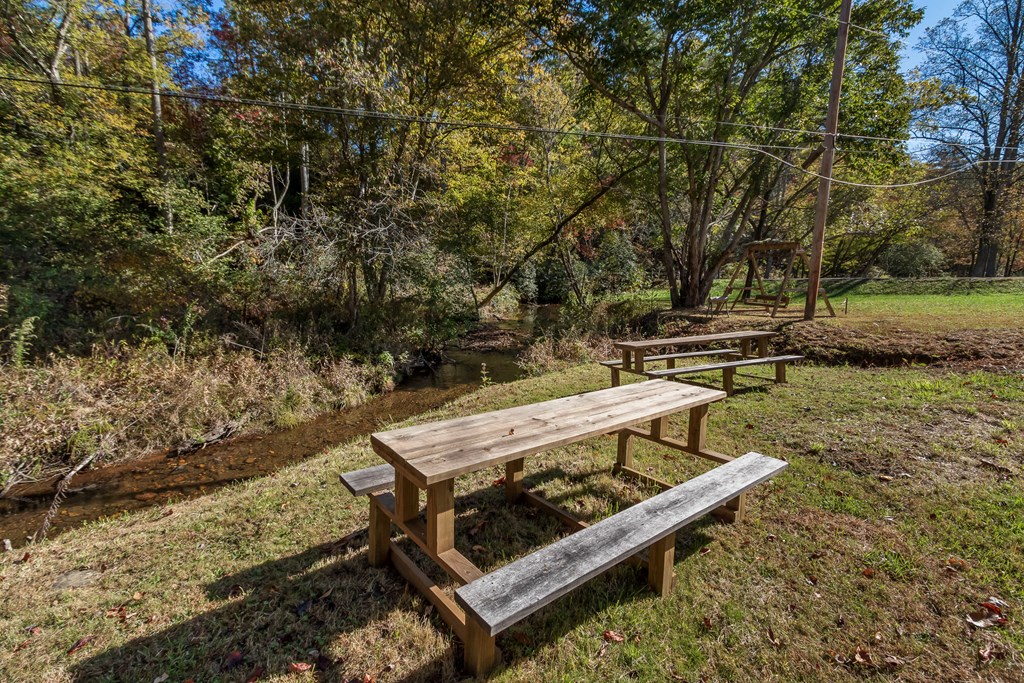 3391 Candy Mountain Road Murphy, NC 28906 - Photo 55 of 59 a view of a yard with wooden deck and a lake