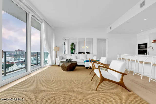 a balcony with furniture and view of living room