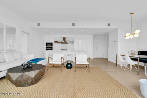 a living room with furniture and a floor to ceiling window