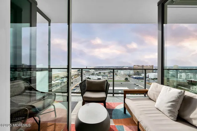 a living room with furniture and a floor to ceiling window