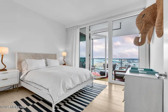 a bedroom with a bed couch and large window