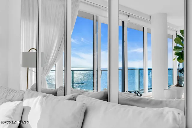 a bedroom with a bed and a large window