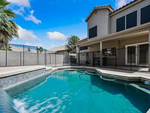 a view of a house with swimming pool and a yard
