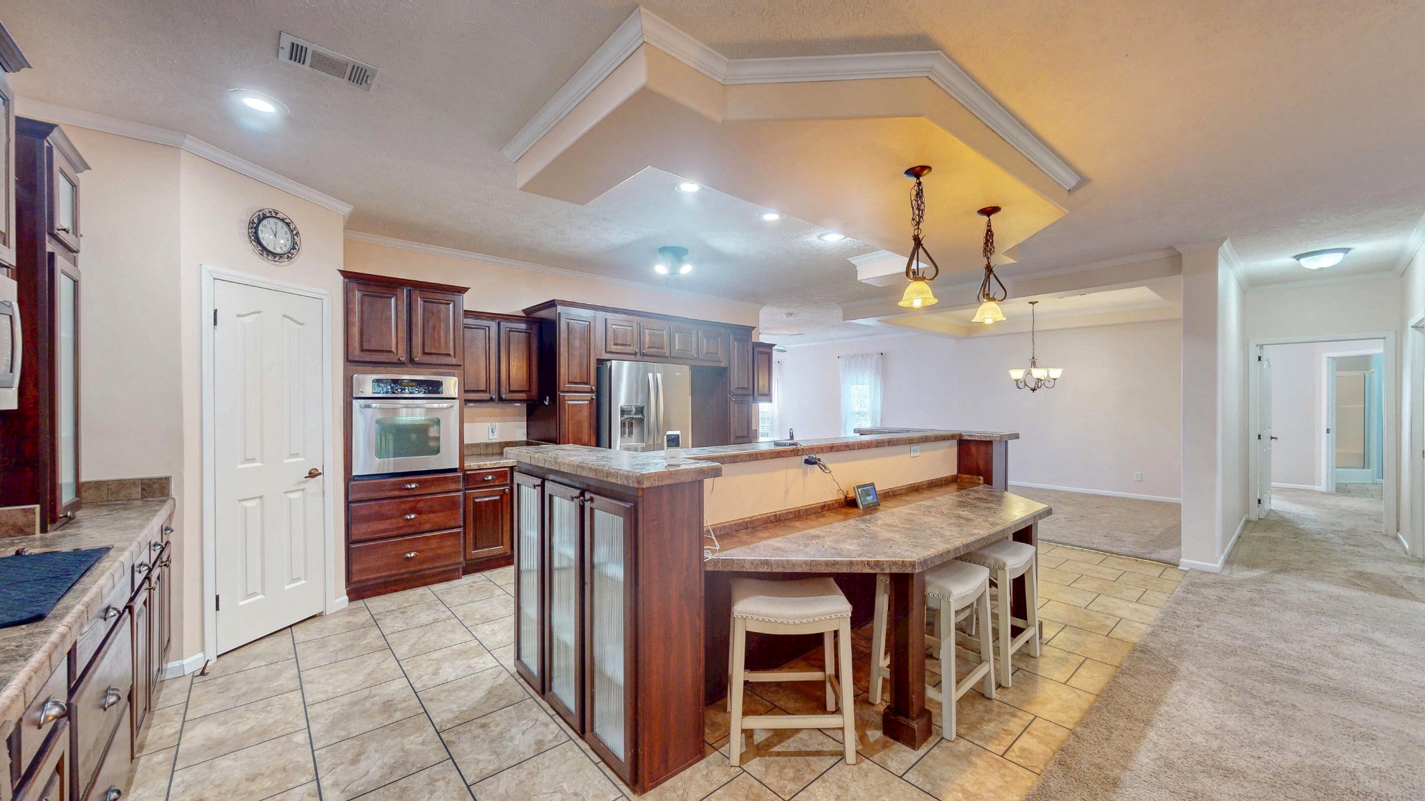 555 Brandon Road Huntingdon, TN 38344 - Photo 17 of 42 a kitchen with stainless steel appliances kitchen island granite countertop a refrigerator and a stove top oven