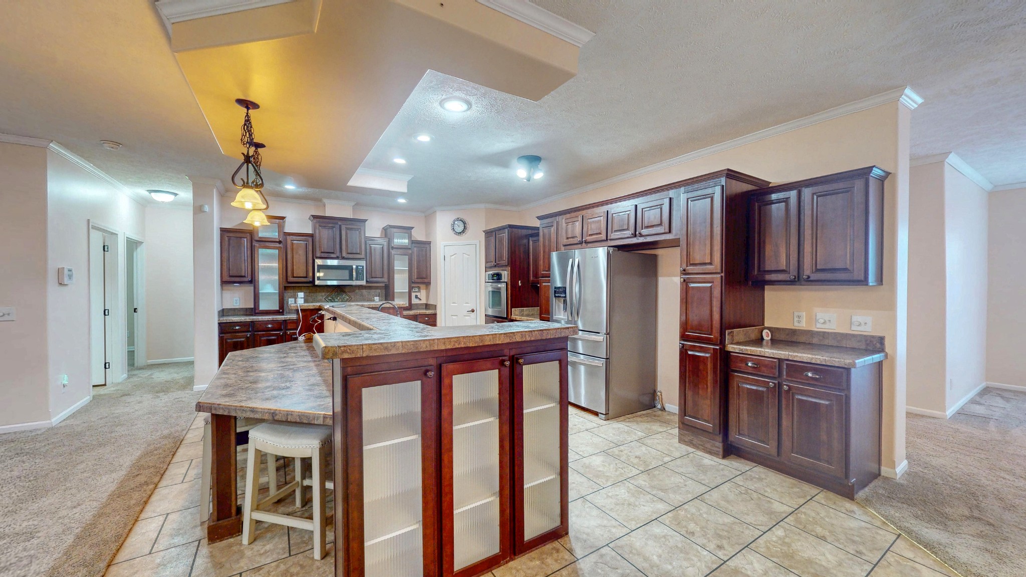 555 Brandon Road Huntingdon, TN 38344 - Photo 20 of 42 a kitchen with stainless steel appliances granite countertop a table chairs sink refrigerator and cabinets